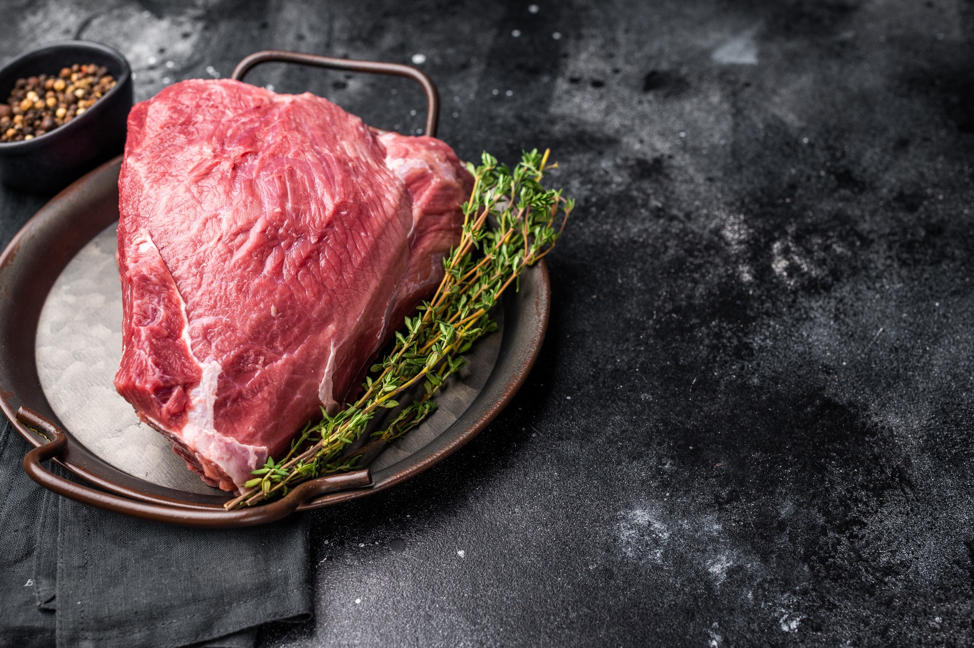 Raw Wild Boar meat, fresh Game Meat. black background. top view