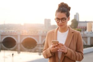 Young businesswoman checking messengers